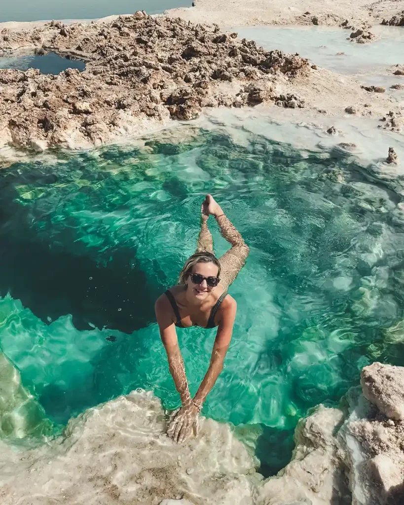 about-me-siwa-oasis Lucy floating on her front in a turquoise salt lake in Siwa Oasis.