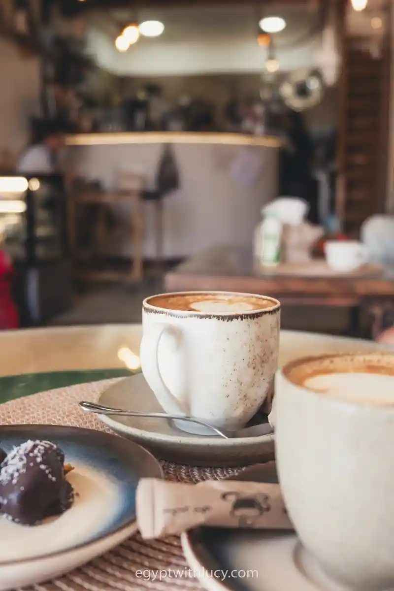 Mugs rest on a table inside Avenue Cafe.