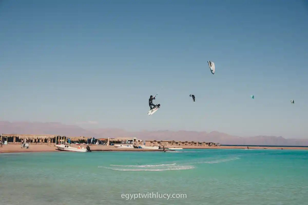 blue-lagoon-beach A kite surfer catches air high above the water at Blue Lagoon Beach.