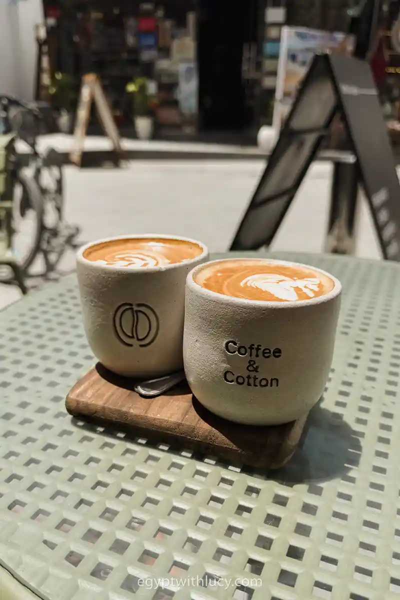 Mugs rest on a patterned table outside Coffee & Cotton.