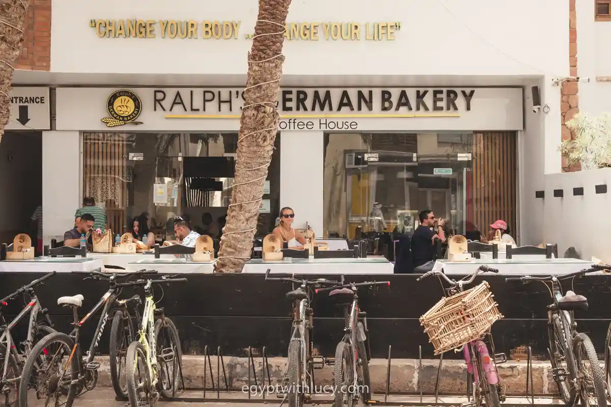ralphs-german-bakery-lighthouse Customers sit at tables behind a row of parked bicycles outside Ralph's German Bakery.