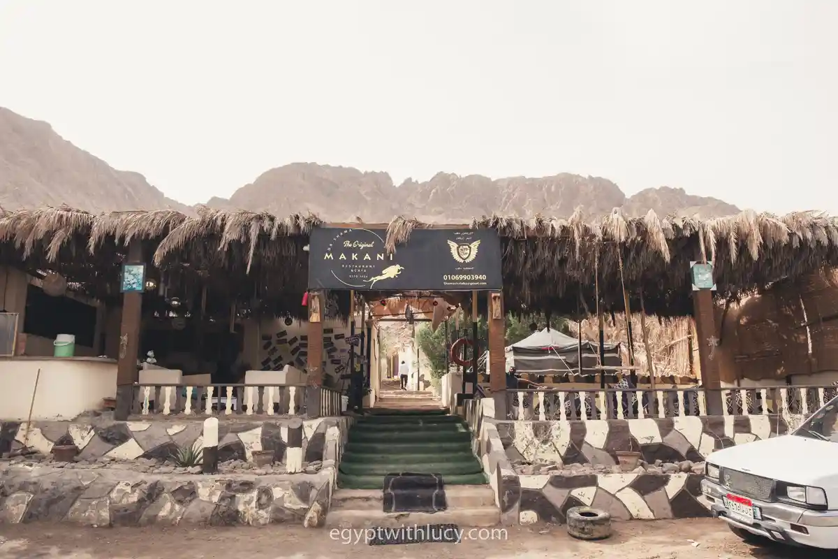Front entrance of Makani Restaurant and Cafe with a mountain backdrop.